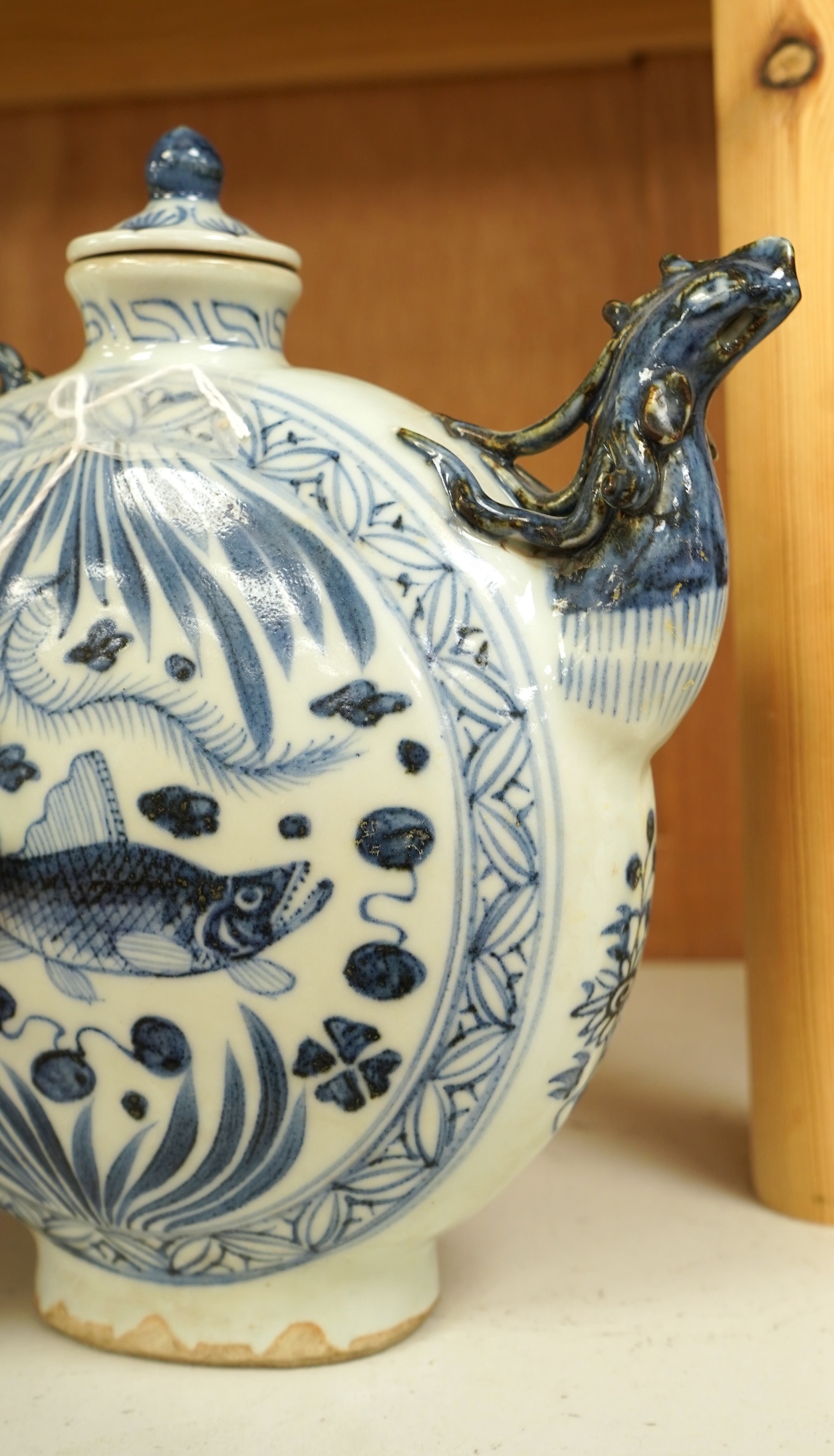 A Chinese blue and white moon flask wine pot with phoenix spout, 21cm high
